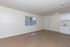 Bright, open living space with modern vinyl flooring and a compact kitchenette, perfect for stylish urban living.