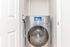 Sleek modern laundry area with a high-efficiency front-loading washing machine and digital interface.