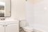 Bright and modern bathroom with sleek fixtures, a spacious countertop, and elegant tiling, offering a refreshing and inviting space.