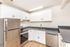 Modern kitchen with sleek stainless steel appliances, elegant white cabinetry, and contemporary countertops offering a clean and inviting space.