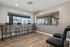 Modern apartment dining area with stylish bar seating and expansive windows showcasing outdoor views and natural light.