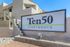 Modern Ten50 Apartments sign with sleek architectural elements and inviting outdoor ambiance.