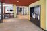 Modern lobby area with stylish decor and ample natural light, featuring a cozy seating area and elegant tile flooring.