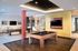 Contemporary recreation room with sleek pool table, stylish lighting, and elegant decor, perfect for entertaining in luxury apartments.