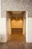 Elegant entrance with textured wall designs and warm wooden flooring, inviting a sense of luxury and style.