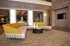 Luxurious modern living room featuring an elegant curved sofa, stylish decor, and a wall-mounted TV.