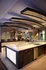 Luxury kitchen featuring elegant curved ceiling design, sleek countertops, and modern appliances for a stylish living experience.
