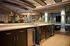 Elegant, spacious kitchen with sleek dark cabinetry, modern lighting, and a stylish island.