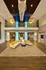 Elegant lobby with modern architecture, featuring a chic circular sofa, stylish chandelier, and ambient lighting.