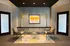 Elegant lobby with contemporary decor, featuring stylish chairs, a modern glass table, and vibrant artwork against a textured wall.