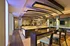 Luxurious modern kitchen with sleek countertops, ambient lighting, and stylish bar seating in a contemporary open space.