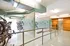 Modern bicycle storage room with sleek railings, vibrant lighting, and convenient wall-mounted bike racks.