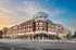 Charming urban apartment complex with contemporary architecture, featuring multiple balconies and vibrant street-level dining options at sunset.