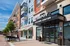 Modern apartment complex with vibrant exterior, featuring balconies and a welcoming leasing center entrance.