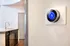 Modern apartment with sleek kitchen design and smart thermostat for energy efficiency.