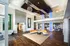 Luxurious and modern apartment lobby featuring sleek wooden floors, contemporary art, and elegant lighting with spacious seating area.