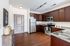 Modern kitchen with sleek stainless steel appliances, rich wooden cabinetry, and elegant granite countertops.