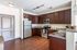 Modern kitchen with elegant dark wood cabinetry, stainless steel appliances, and sleek granite countertops.