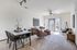 Elegant open-concept living space featuring a chic dining area and stylish furnishings bathed in natural light.