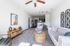 Bright and inviting living room with modern decor, plush seating, and a cozy atmosphere, leading seamlessly into a chic kitchen area.