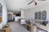 Bright and inviting living room with cozy seating, elegant decor, and a modern open-concept kitchen.