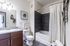 Elegant bathroom with modern fixtures, granite countertop, and stylish tile work, perfect for a luxurious home experience.