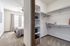 Inviting bedroom adjoining a spacious walk-in closet with ample shelving and natural light.