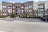 Inviting apartment complex with modern architecture, featuring a welcoming leasing office entrance and elegant balconies.