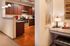 Modern kitchen with sleek dark wood cabinets, stainless steel appliances, and elegant granite countertops, complete with cozy ambient lighting.