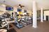 Modern fitness center with state-of-the-art treadmills, flat-screen TVs, and ample natural light.