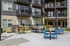 Modern apartment exterior showcasing stylish balconies and vibrant outdoor seating, perfect for relaxing and entertaining.