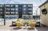 Modern apartment complex featuring a sparkling outdoor pool, stylish lounge chairs, and inviting seating area with yellow wicker chairs and fire pit.