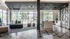 Modern apartment common area with sleek design, featuring a stylish lounge, natural light, and contemporary kitchen space.