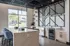 Modern kitchenette with seamless marble countertop, stylish bar stools, and large window offering abundant natural light.