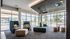 Modern and inviting lounge area with stylish seating, floor-to-ceiling windows, and elegant lighting fixtures.