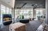 Modern lounge area with floor-to-ceiling windows, stylish seating, and contemporary lighting, offering an inviting and open space for relaxation.