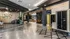 Modern apartment lobby featuring sleek black lockers, stylish seating, and contemporary decor with open shelving.