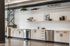 Modern kitchen with sleek light wood cabinetry, open shelving, and stainless steel appliances, accented by contemporary decor and ample counter space.