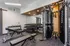 Contemporary fitness center featuring state-of-the-art equipment, free weights, and versatile benches in a sleek, modern design.