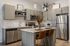 Modern kitchen with sleek cabinetry, stainless steel appliances, and a stylish island perfect for casual dining and entertaining.