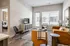 Modern living room with stylish furniture, large windows, and natural light, adjacent to a cozy bedroom.