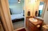 Inviting bedroom and modern en-suite bathroom with elegant decor and ample natural light.