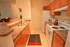 Warm and inviting kitchen with modern appliances, ample counter space, and stylish wood cabinetry, perfect for culinary enthusiasts.