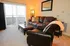 Inviting living room with plush leather seating, modern decor, and natural light from large sliding doors.