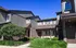 Charming townhouse with modern architecture, lush landscaping, and inviting entrance in a serene neighborhood.