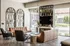 Contemporary living room with stylish leather sofas, elegant geometric decor, and large windows offering abundant natural light.