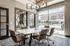 Modern meeting room with stylish decor, large window views, and elegant lighting, perfect for creative and professional gatherings.