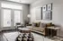 Chic living room with modern decor, cozy sofa, and elegant wall art, bathed in natural light from large windows.