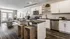 Elegant open-concept kitchen and living area with modern appliances, stylish island, and chic decor.
