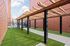 Charming urban outdoor space featuring a wooden pergola and lush green artificial grass.